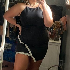 Black formal dress with silver cross over band.